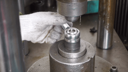 Factory press machine adjusting rod end torque levels to F1, F2, and F3 by applying controlled pressure on the outer ring