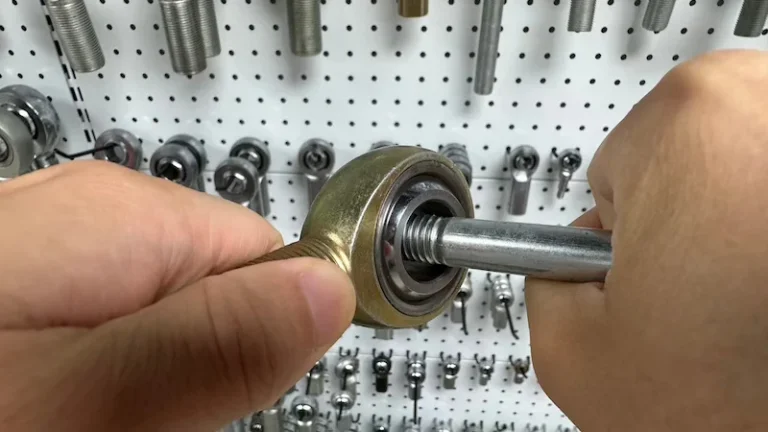 Demonstration of F1 torque rod end where a person uses a lever bar to rotate the ball due to very high resistance
