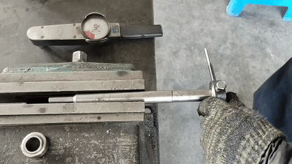 Engaging a dial torque gauge by sliding its hex socket onto the fixture’s hex head