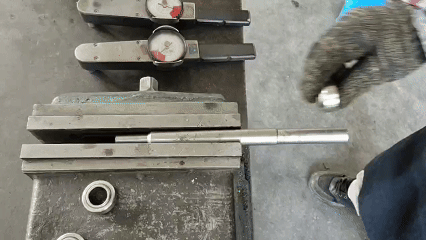 Mounting a spherical bearing onto a steel rod fixed in a vise for torque measurement